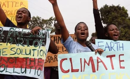 Young people hold up banners as they take part in a march, part of the global Climate Walk 2019, against climate change in Wakiso, on September 20, 2019.
